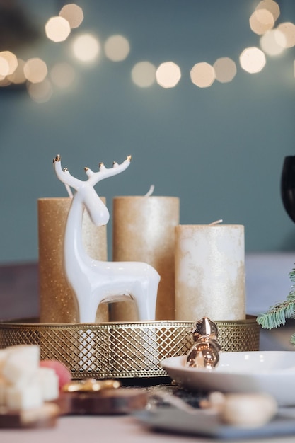 Christmas table in the living room with the objects of holiday decor. New Year eve concept