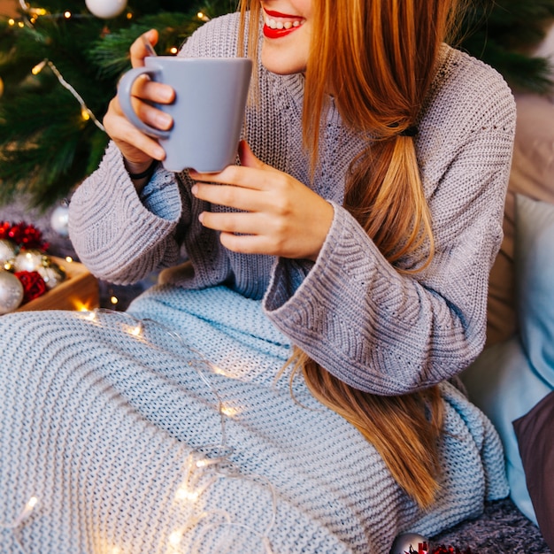 Free Photo christmas and tea concept with young woman