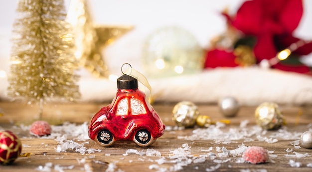 Christmas toy car and details of Christmas decor on a blurred background