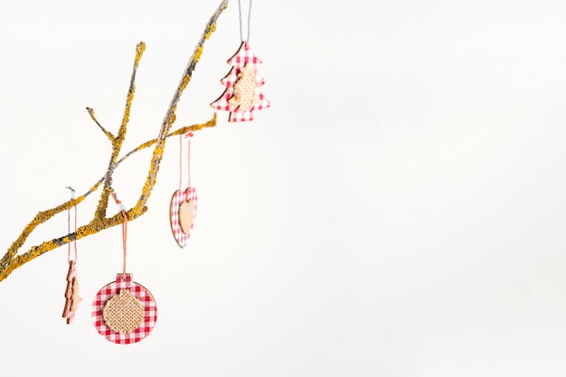 Free photo christmas toys hanging on tree branch