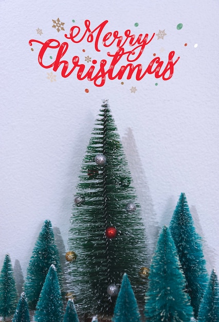 Free Photo christmas tree decoration and text merry christmas on wall background.