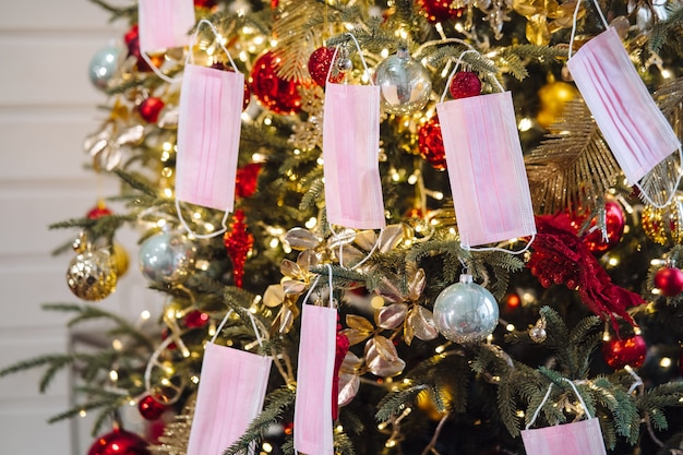 The Christmas tree was decorated with protective masks. Christmas during coronavirus, concept