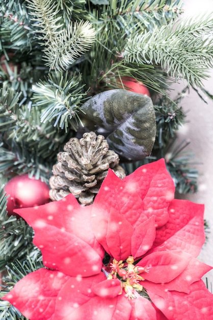 Christmas tree with pine cones and a red flower