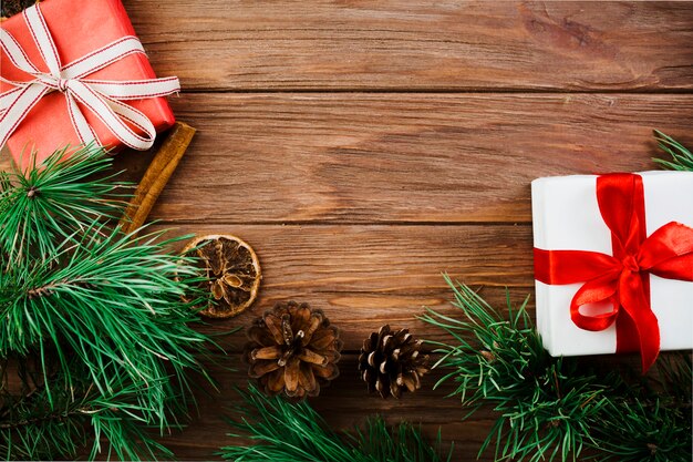 Christmas twig and present boxes on wooden desk