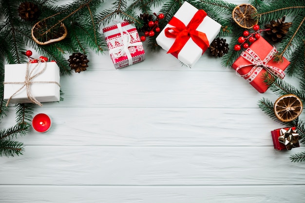 Christmas twig with candle and present boxes