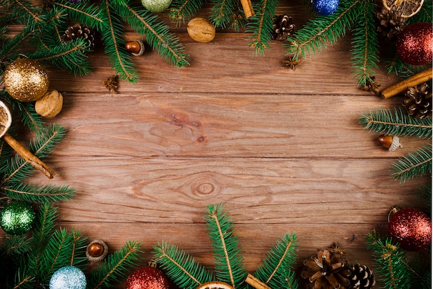 Christmas twigs and ornament balls on wooden desk