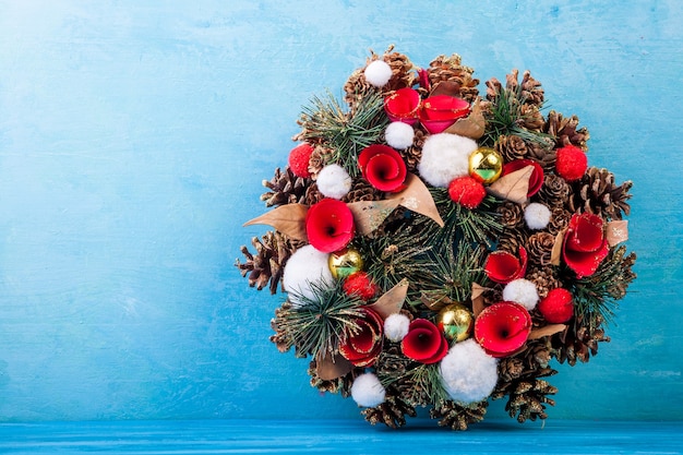 Free Photo christmas wreath on blue wooden background in studio photo