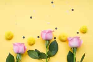 Free photo chrysanthemum and pink roses flower on yellow background