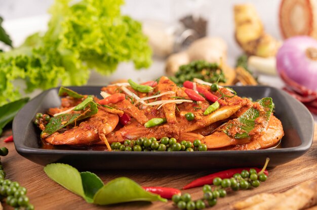 Chuchi shrimp on a plate with fresh pepper seeds