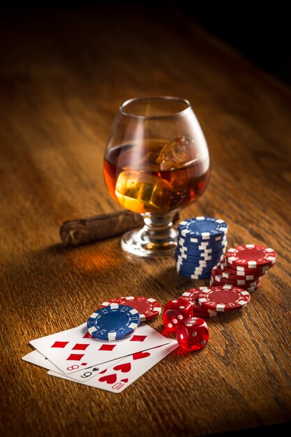 Cigar, chips for gamblings, drink and playing cards