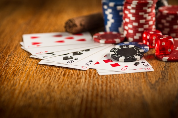 Cigar, chips for gamblings, drink and playing cards