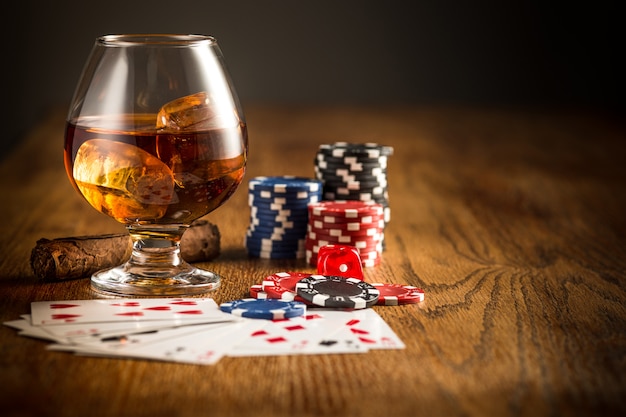 Free photo cigar, chips for gamblings, drink and playing cards