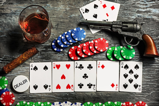 Cigar, chips for gamblings, drink and playing cards