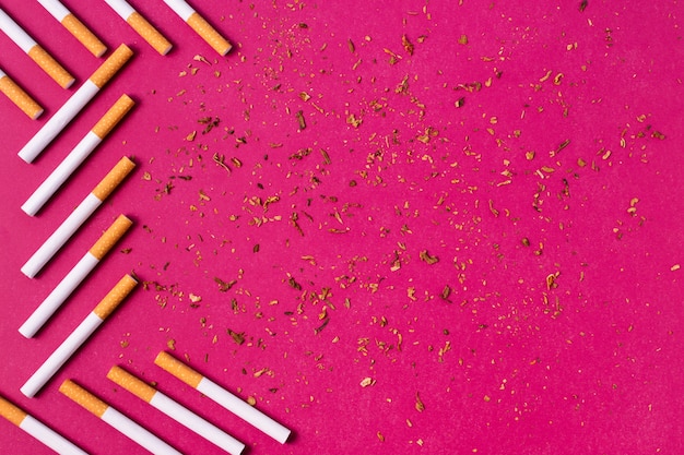 Cigarettes frame on pink background