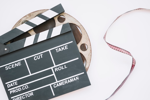 Free photo cinema clapperboard with a film reel