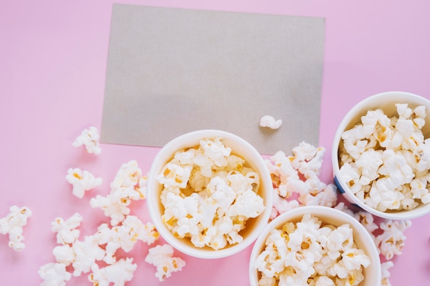 Cinema concept with popcorn and card