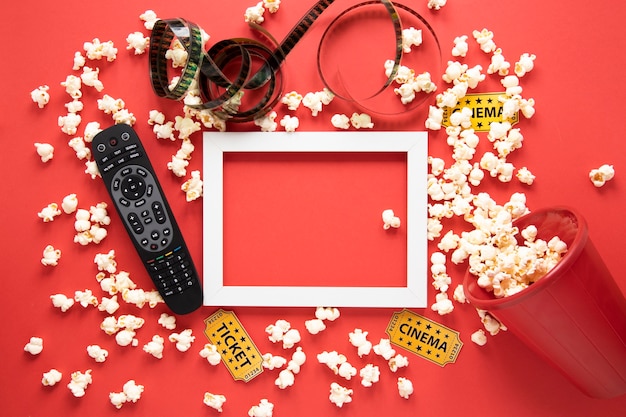 Free photo cinema elements and white frame on red background