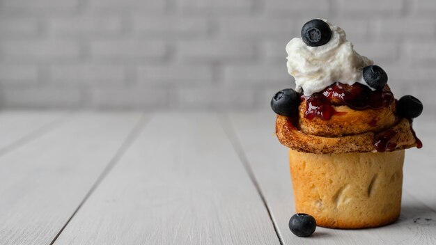 Cinnamon roll with whipped cream and fruits