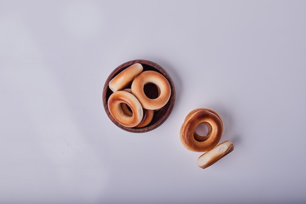 Circle crackers or pastry buns in a wooden cup,  top view.