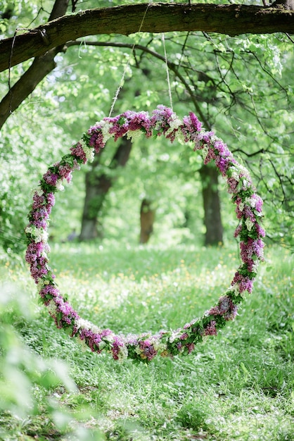 Free Photo circle made of violet and white lilac hangs from the tree