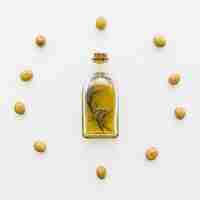 Free photo circle of olives and bottle of oil