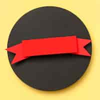 Free photo circular geometric shape of black paper on yellow background