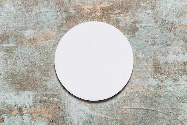 Circular white frame on old wooden desk