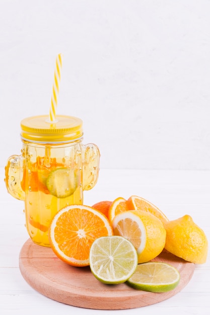 Citrus fruits and juice on wooden board