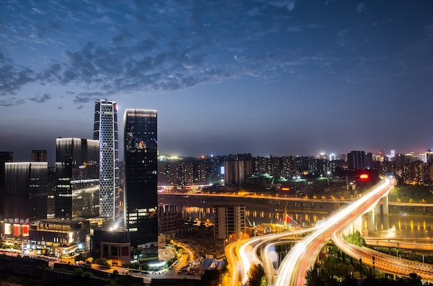 city interchange overpass at night with purple light show in chong qing