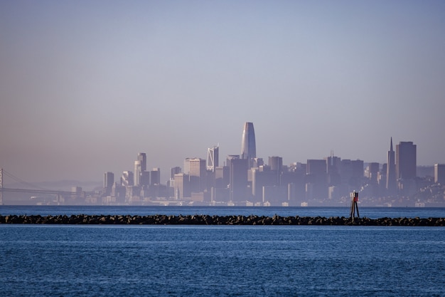 City skyline across body of water during daytime