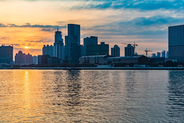 Free photo city skyline by river against cloudy sky