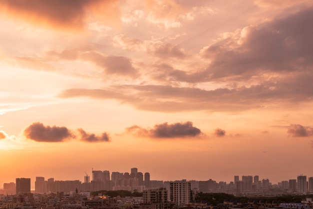 Free Photo cityscape of a city under a cloudy sky during the sunset in the evening