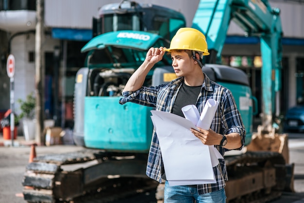 Civil engineers work on large road and machinery conditions.