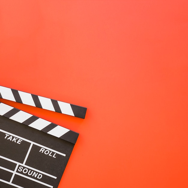 Clapperboard on red background with space on right