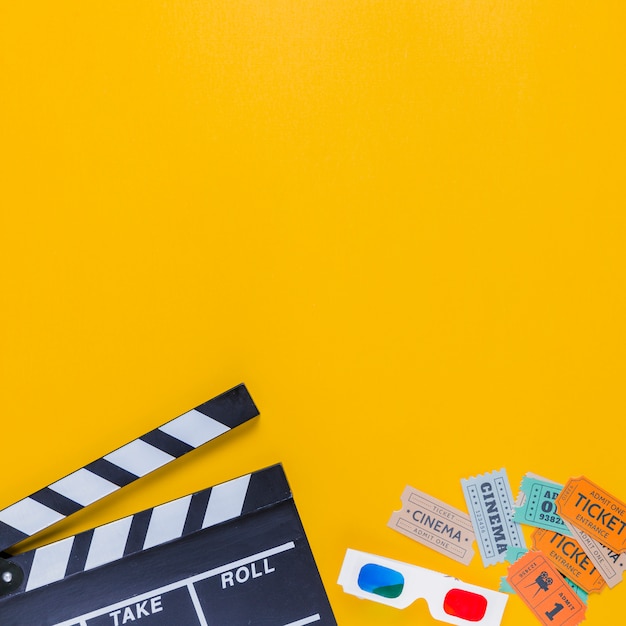 Clapperboard with cinema tickets and 3d glasses