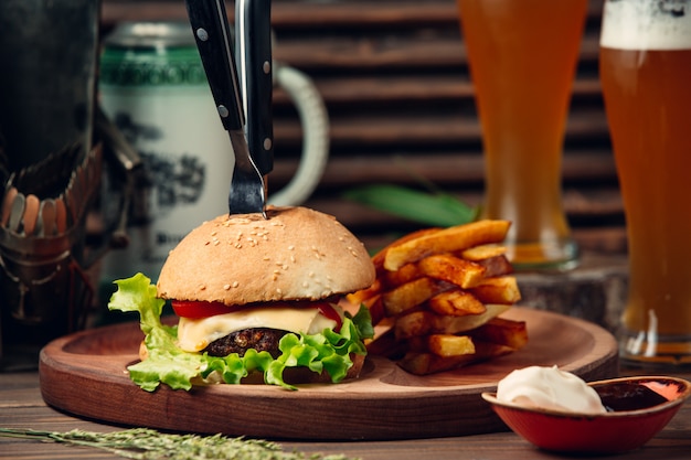 Classic cheeseburger with fries and beer