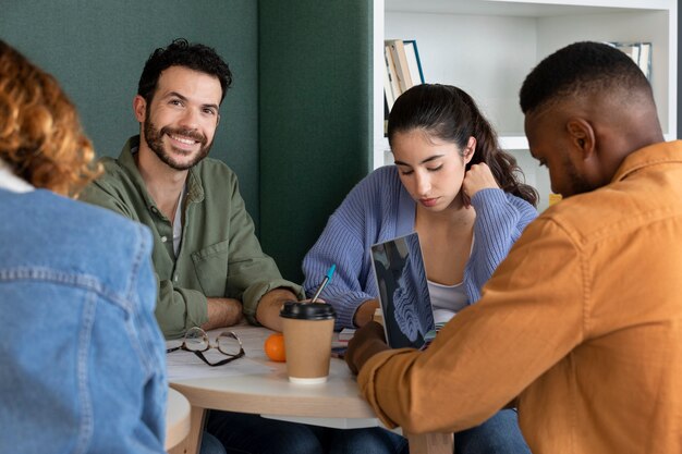 Classmates reading and learning from notes and laptop