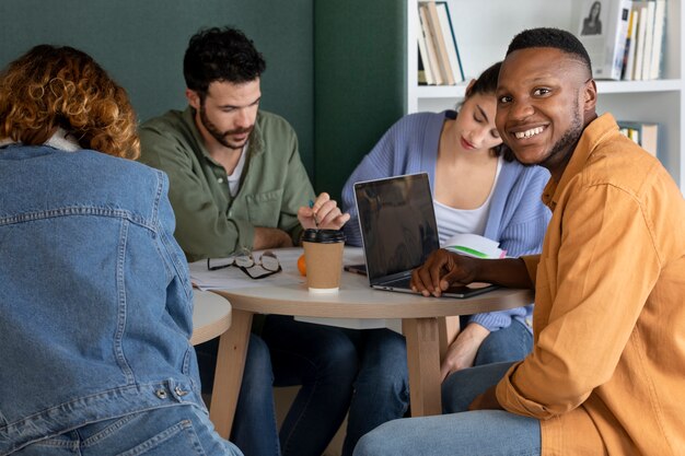 Classmates reading and learning from notes and laptop