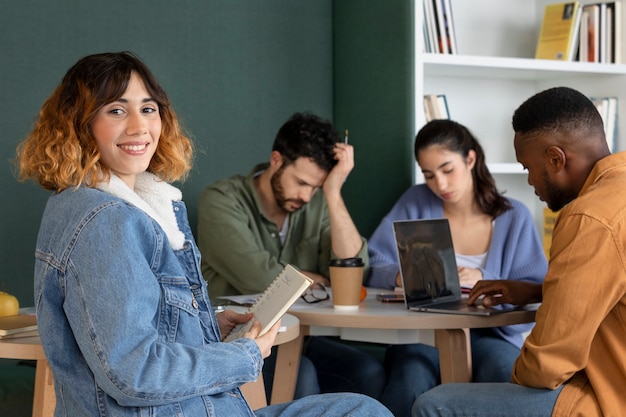 Classmates reading and learning from notes and laptop