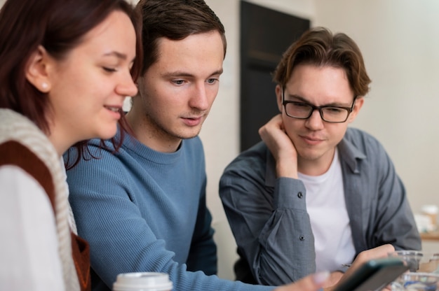 Classmates using smartphone during group study