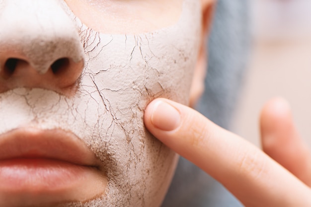 Free photo clay facial mask on female face, close up.