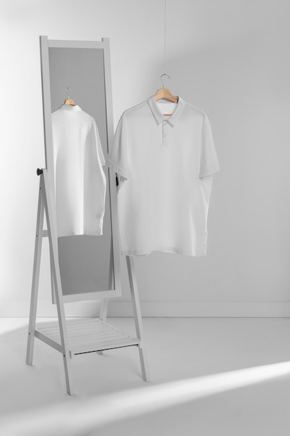 Free Photo clean and blank shirt on hanger by the mirror