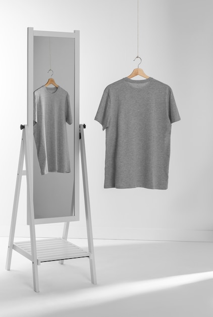 Free Photo clean and blank shirt on hanger by the mirror