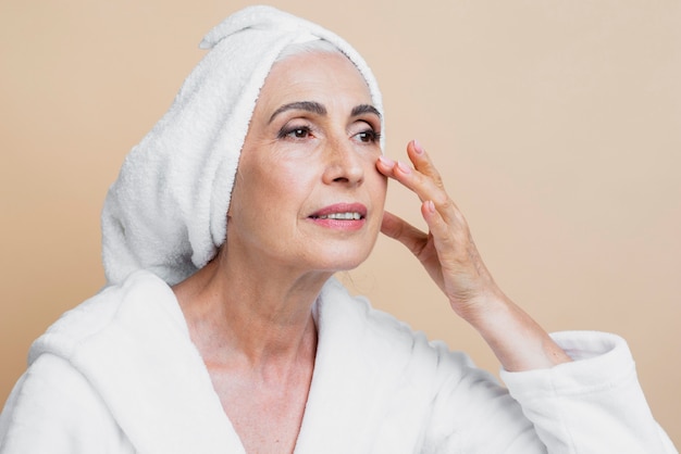 Clean senior woman in bathrobe