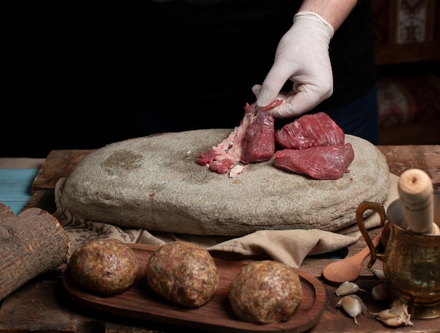 Cleaning and sorting raw meat for making meatballs