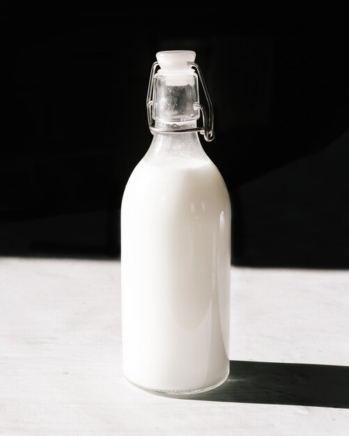 Clear glass bottle filled with white liquid