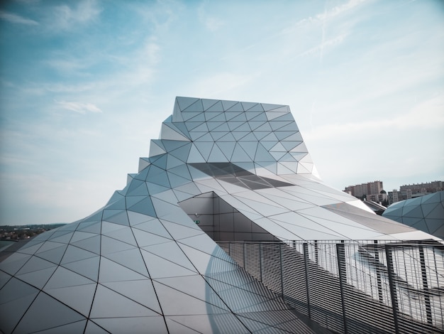 Clear glass-walled building under blue sky