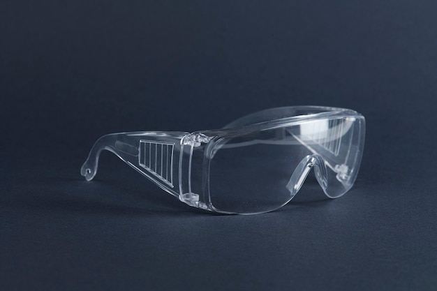 Free photo clear goggles on a dark blue surface