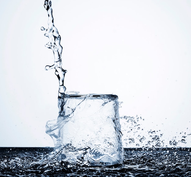 Clear water motion in glass on light background