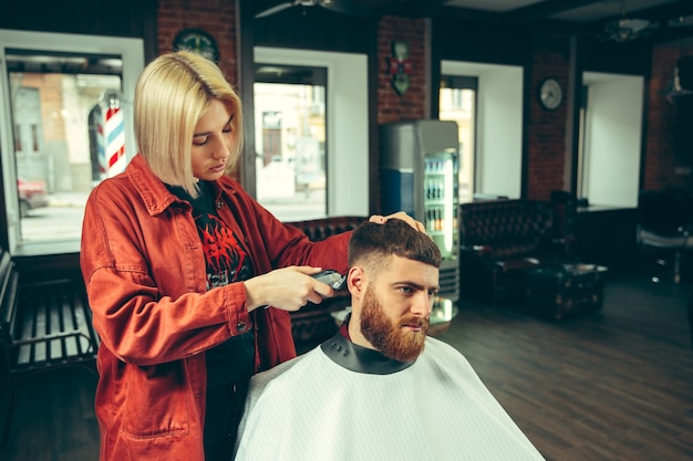 Client during beard shaving in barbershop